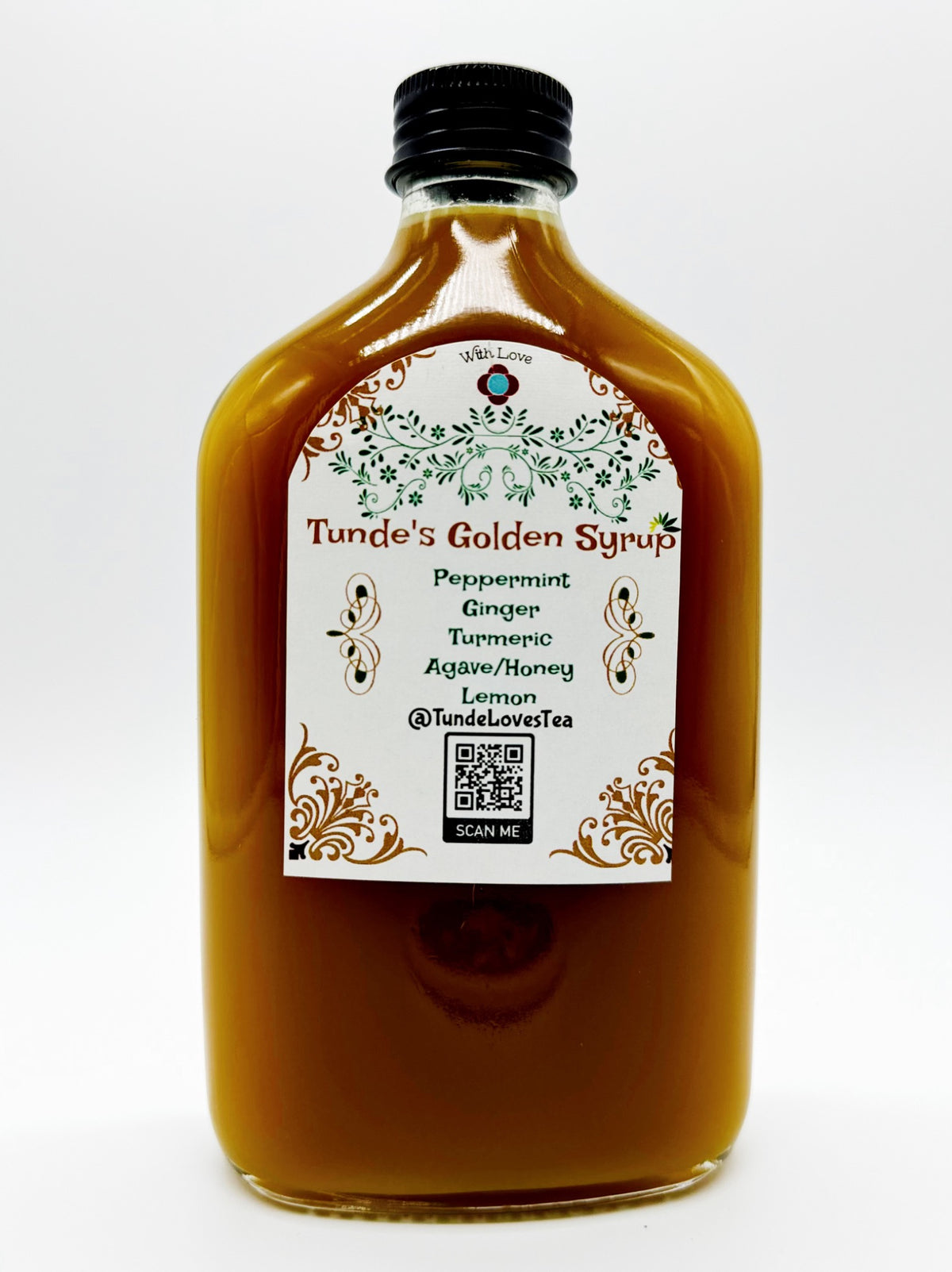 Tunde's Golden Syrup in a glass bottle; the label lists peppermint, ginger, turmeric, agave and honey, and lemon.